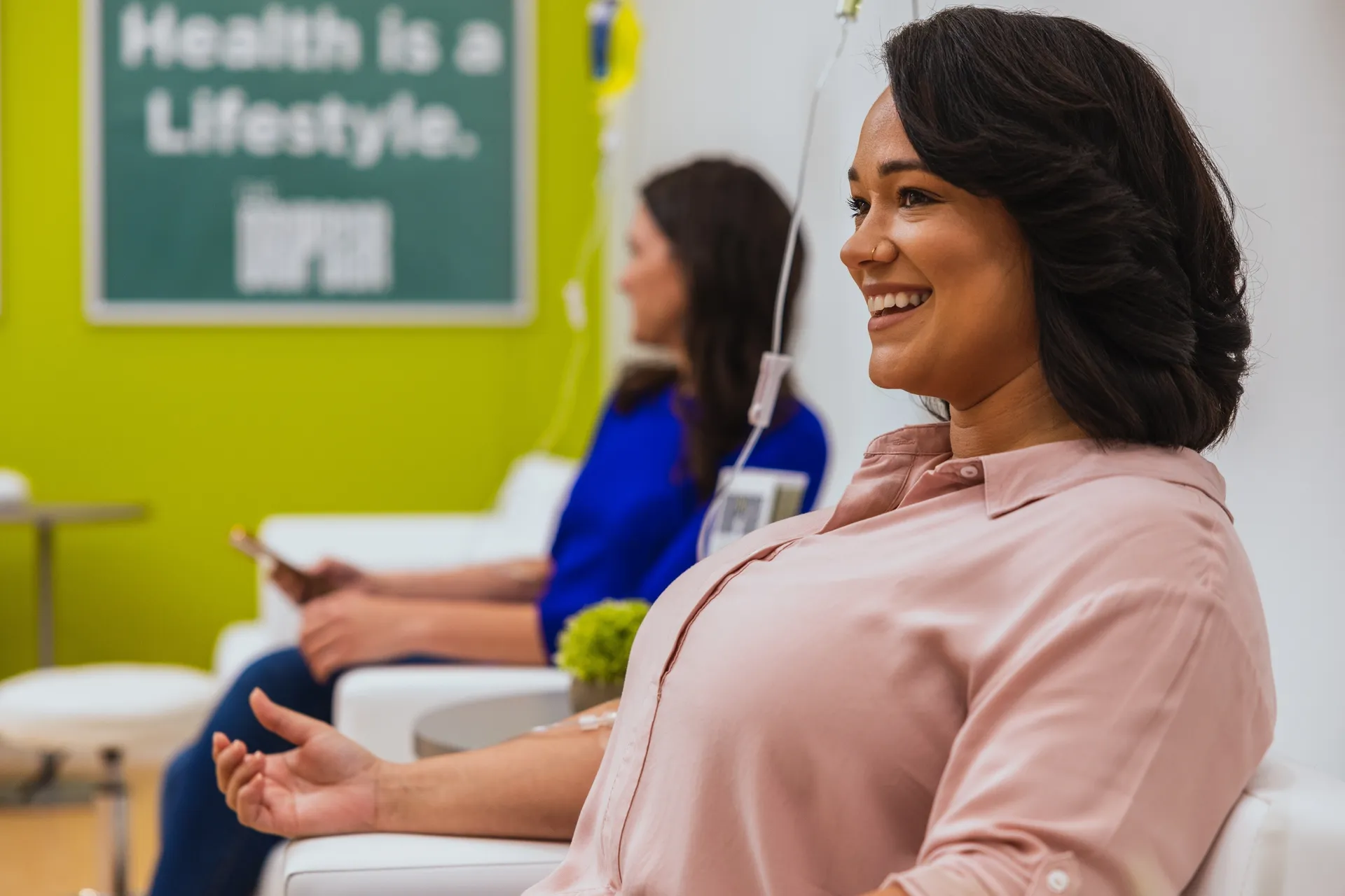 A client smiling during her drip