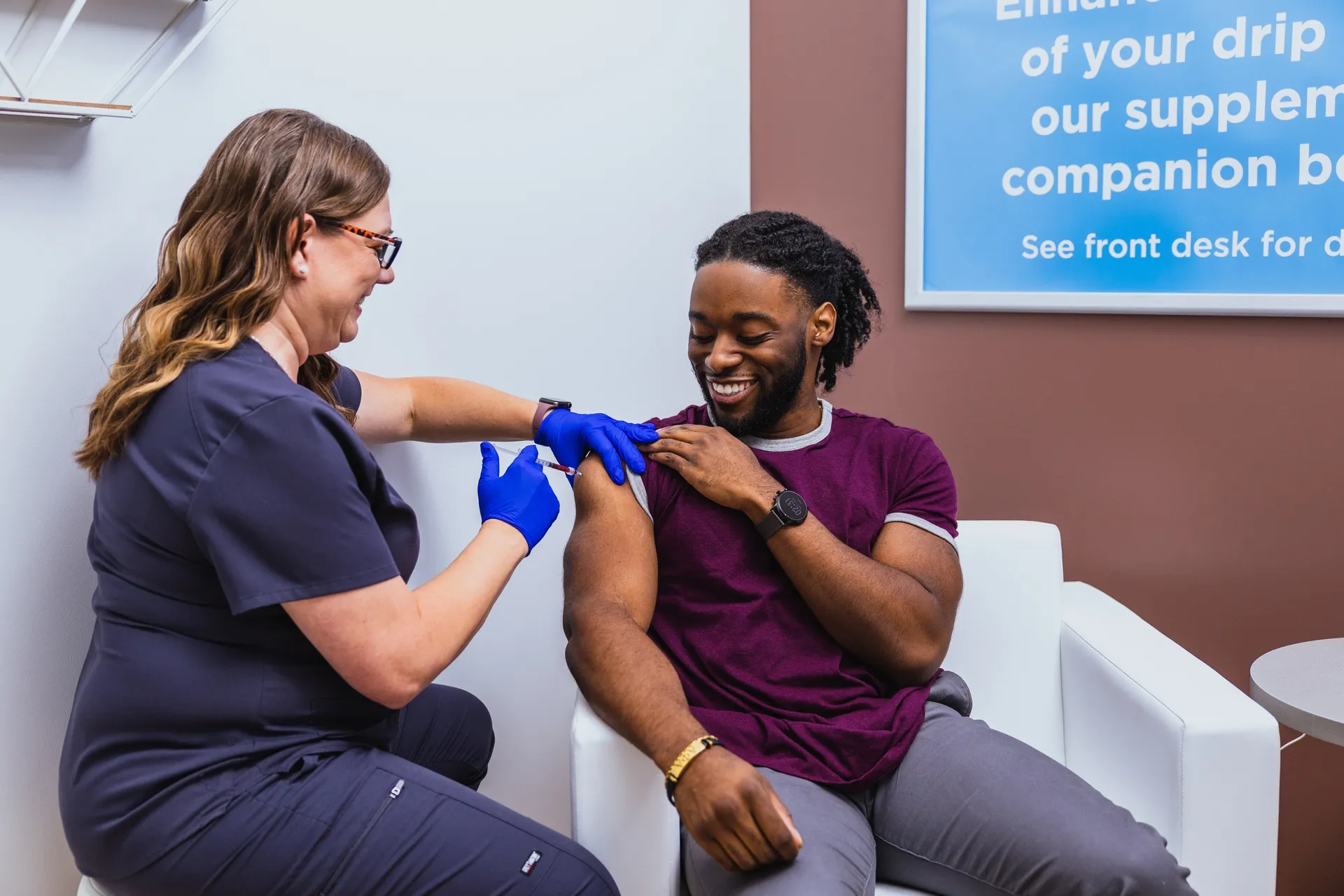 A nurse taping an IV for a client