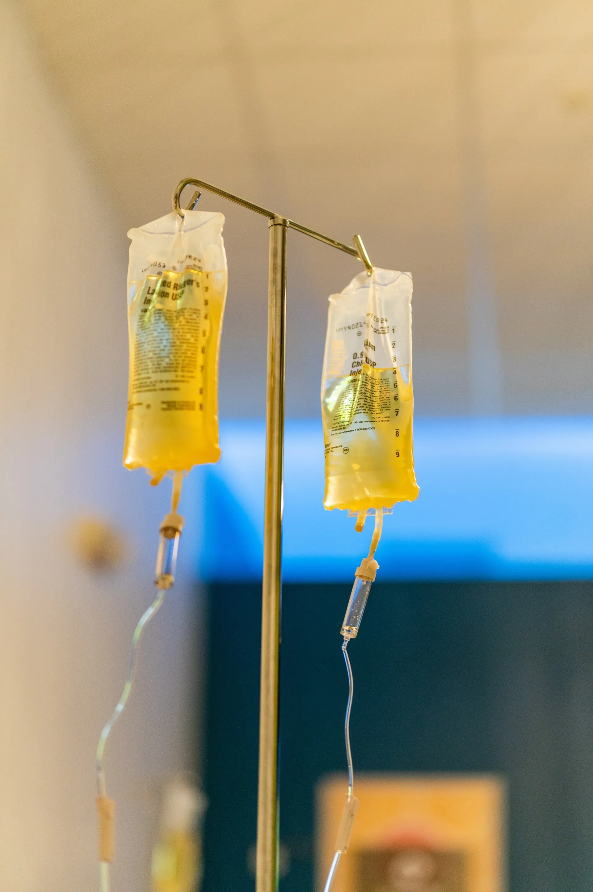 Two vitamin IV bags on a stand