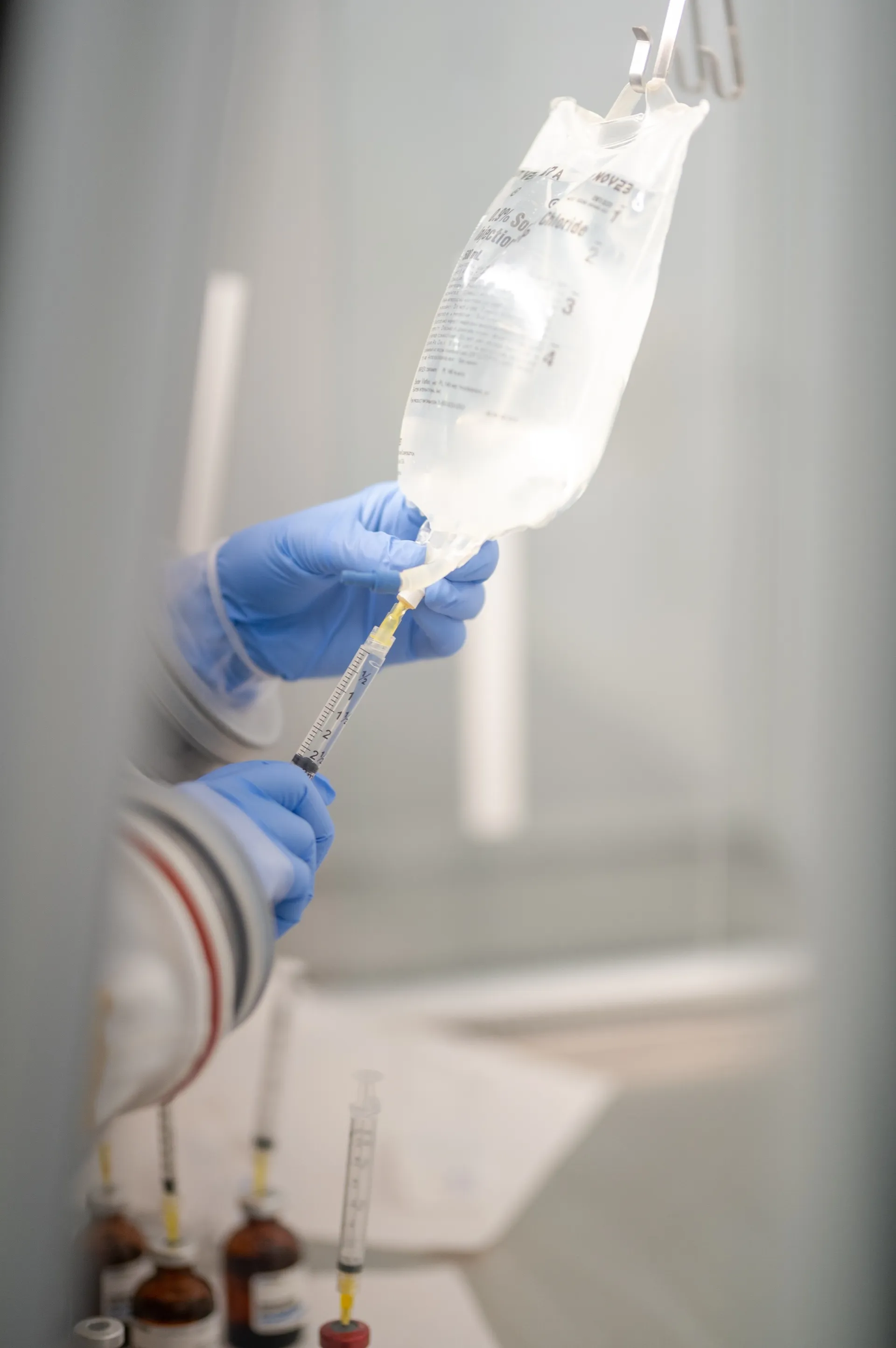Injecting vitamins into an IV bag